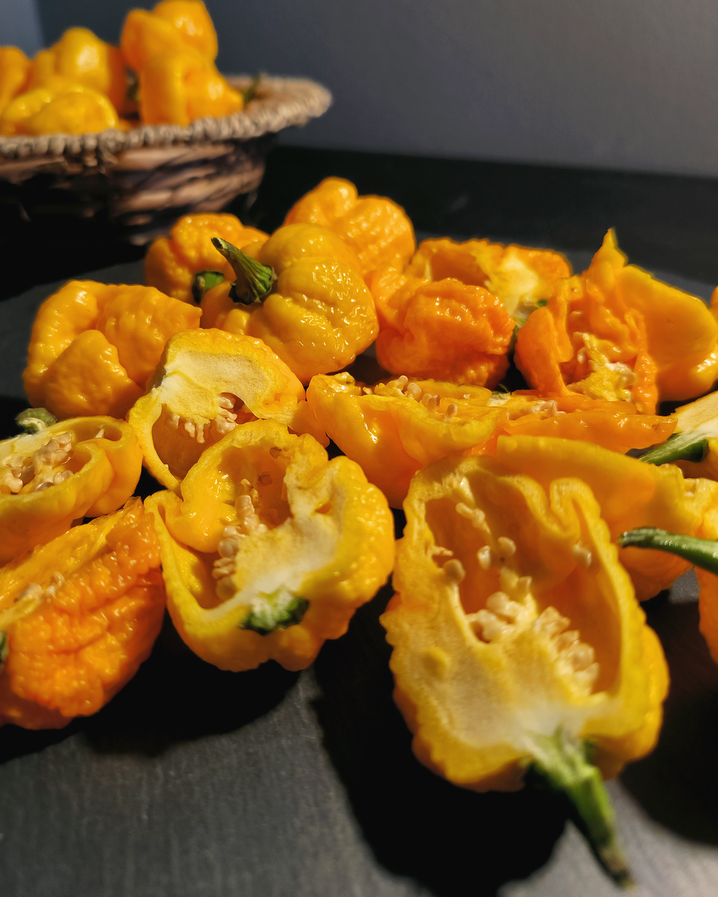 Yellow Moruga Scorpion peppers cut open – interior structure showing seeds and membrane 